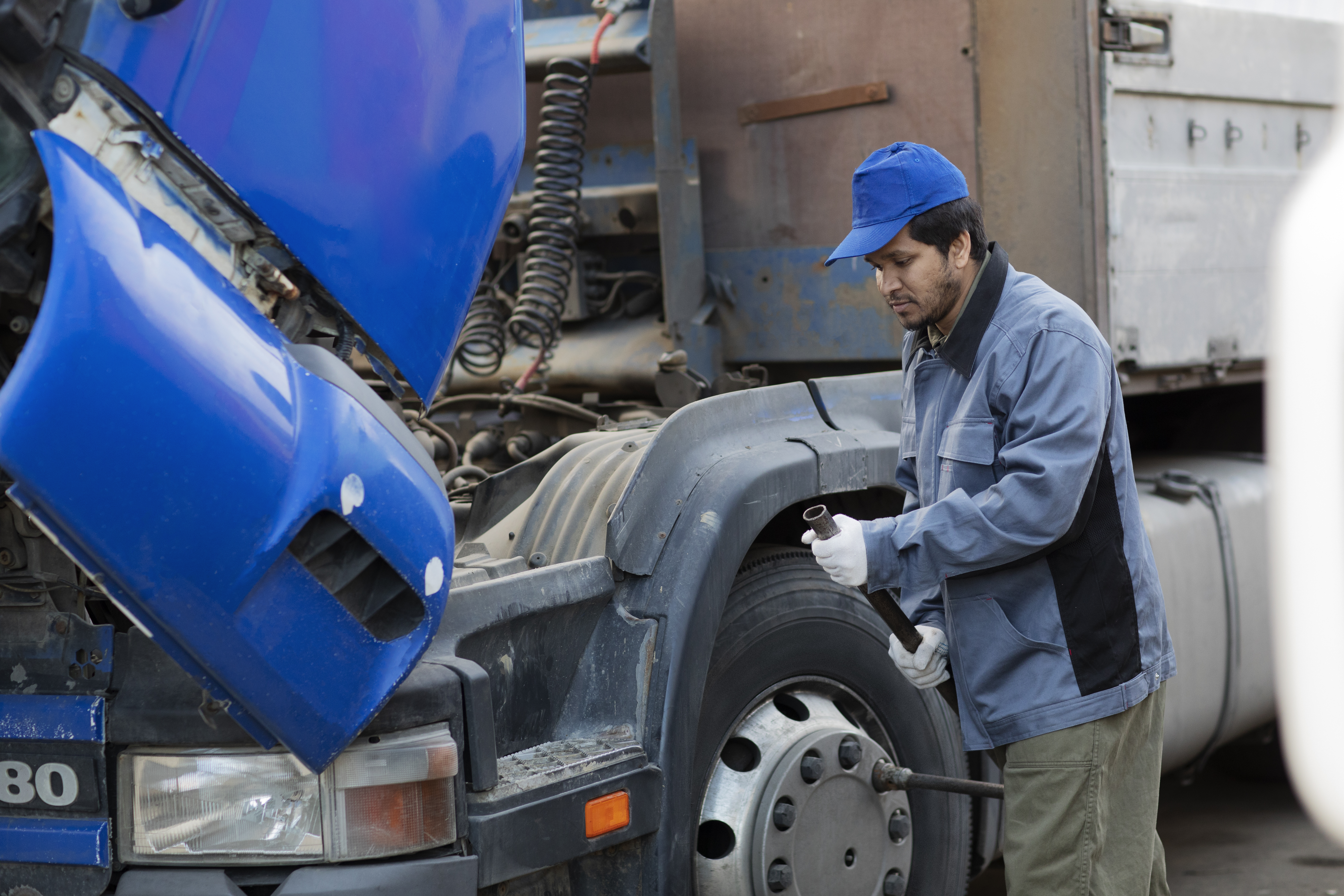 Technician performing truck maintenance to keep fleet vehicles reliable and road-ready
