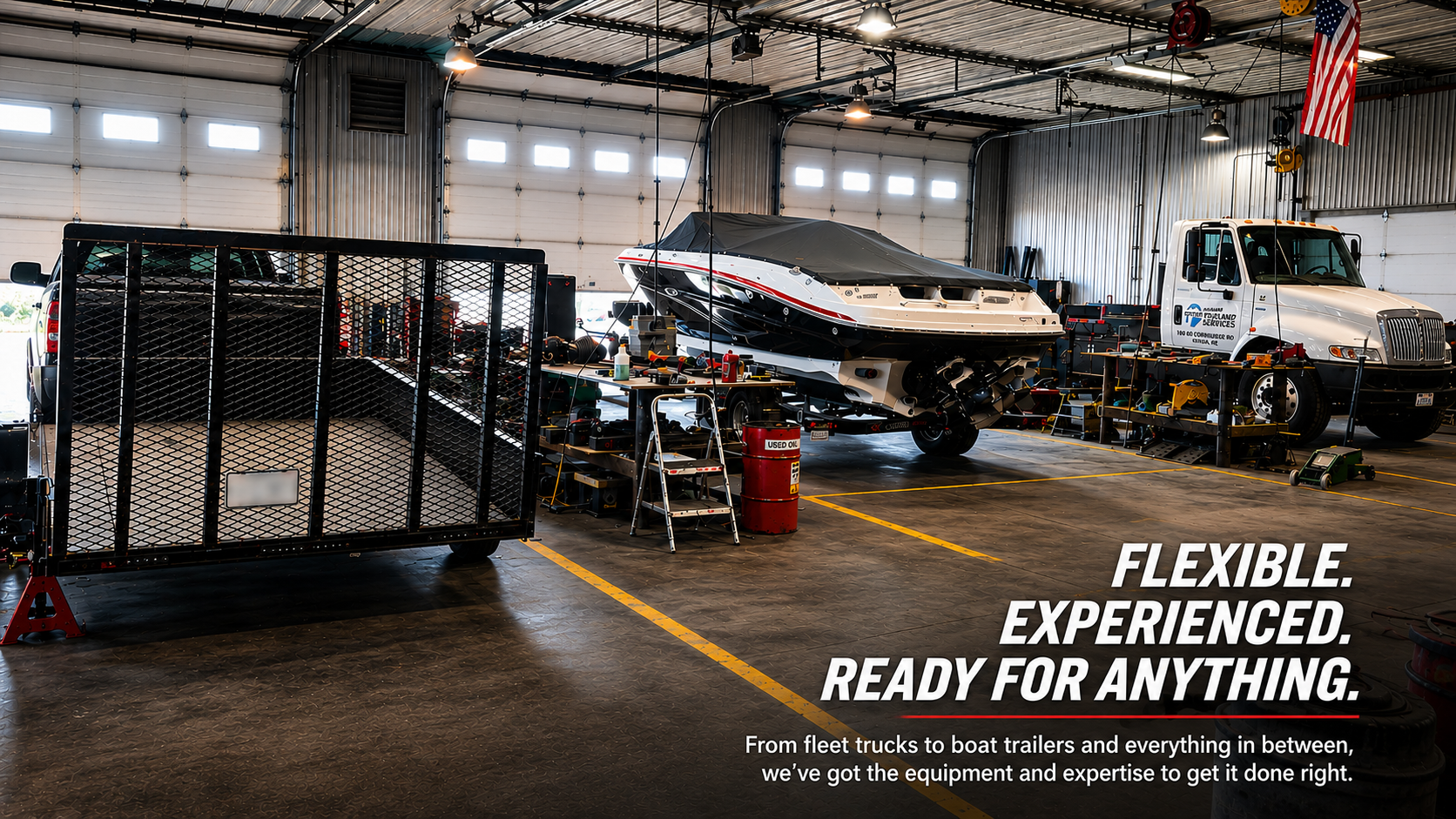Inside the STS Truck Services shop showing a commercial truck, trailer, and specialty equipment project being serviced.