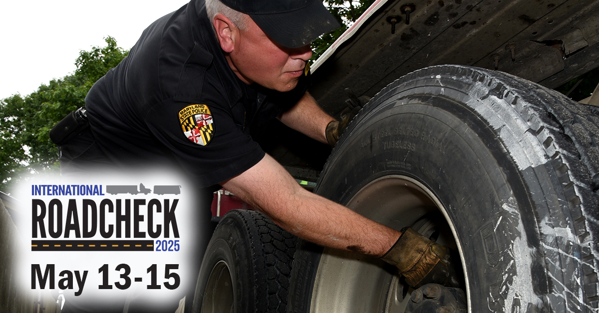 DOT officer inspecting semi truck tires during CVSA Roadcheck inspection